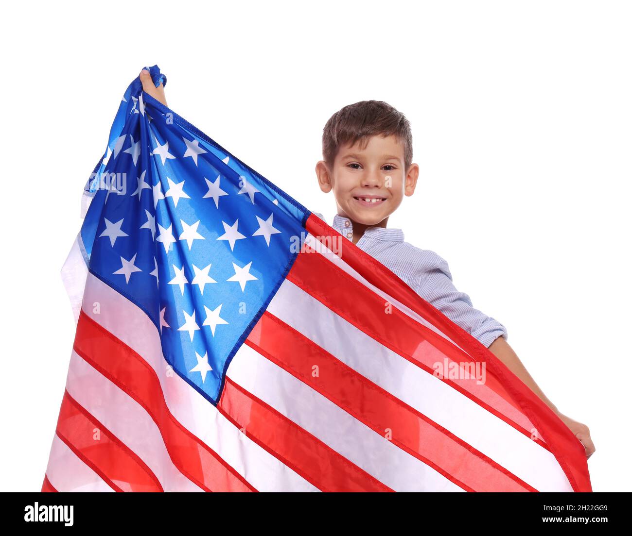 Portrait of cute little boy with American flag on white background ...