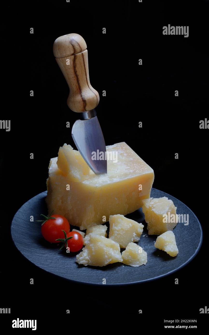 Cheese knife and cut Parmesan cheese on plate, Germany Stock Photo Alamy