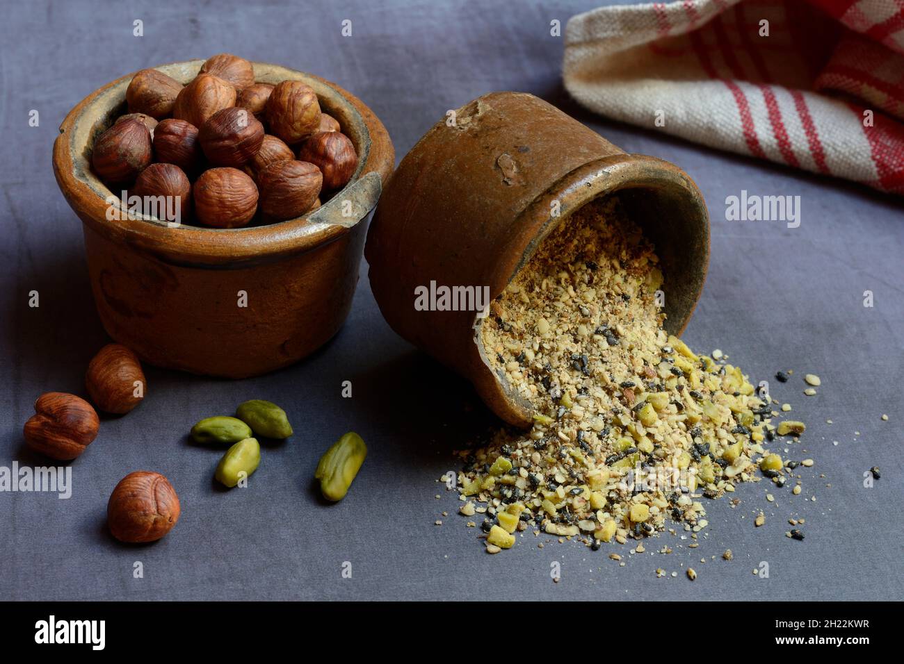 Dukkah, Arabic spice mixture in clay pots and nuts Stock Photo