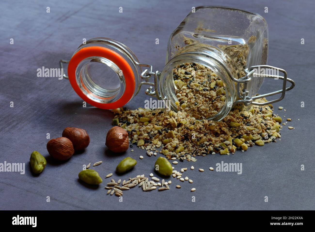 Dukkah, Arabic spice mix in glass container, nuts Stock Photo Alamy