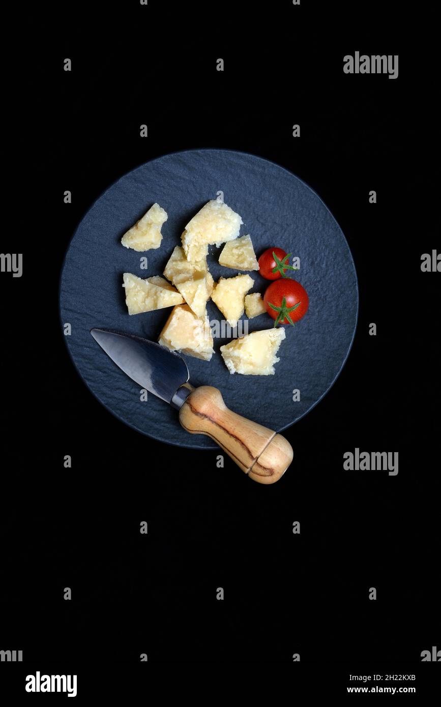 Cheese knife and cut Parmesan cheese on plate, Germany Stock Photo Alamy