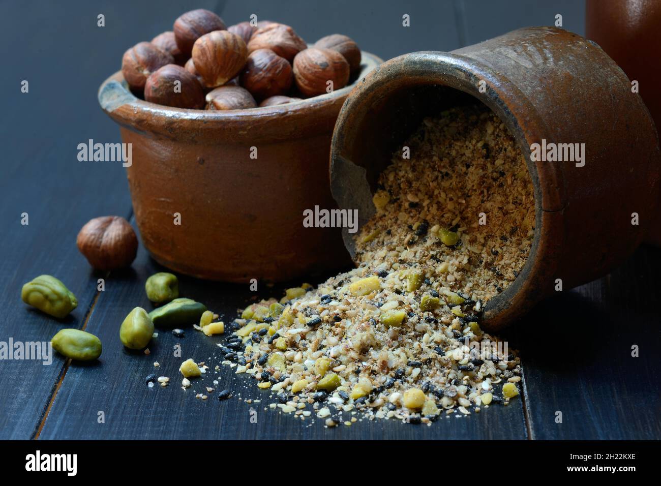 Dukkah, Arabic spice mixture in clay pots and nuts Stock Photo