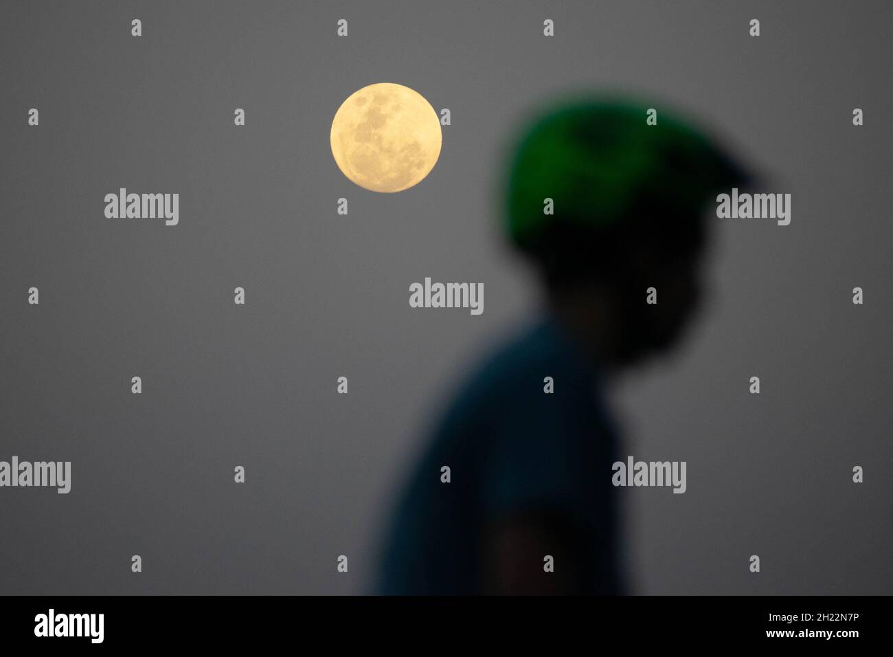 Santiago, Metropolitana, Chile. 19th Oct, 2021. A child rides a bicycle in a bike park, and in the background the almost full moon of October, in Santiago, Chile. (Credit Image: © Matias Basualdo/ZUMA Press Wire) Stock Photo