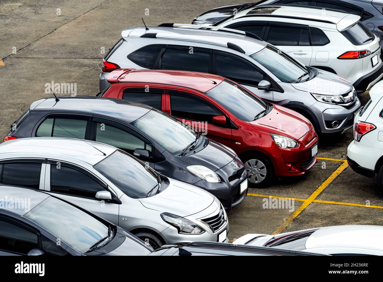 Car parked at parking lot of the airport for rental. Aerial view of Eco car parking lot of airport. Used luxury SUV car for sale and rental service. Stock Photo