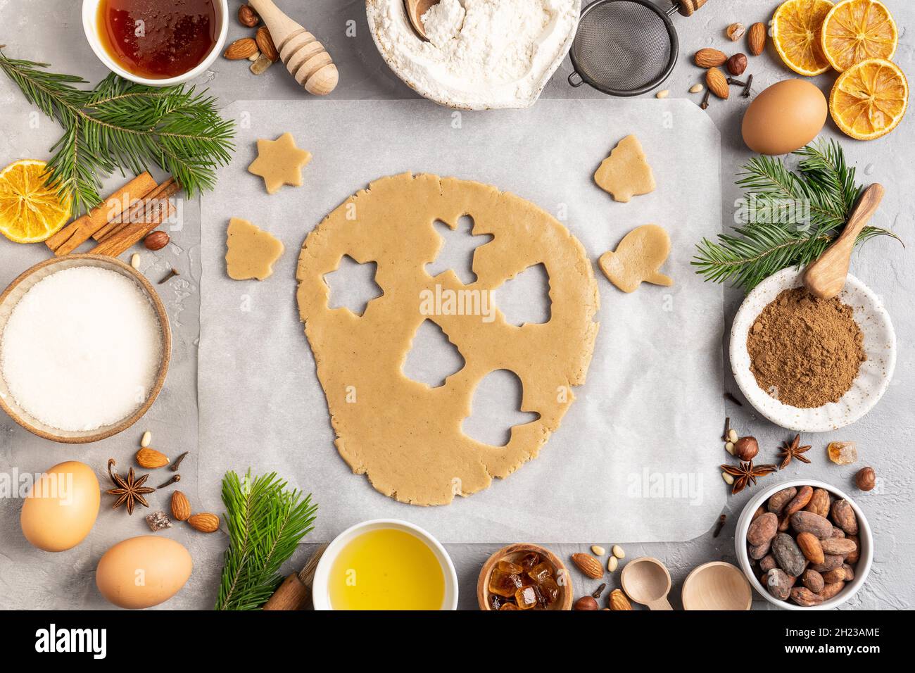 Flour New Year background. Christmas tree branches, gingerbread cookies,  spices and baking supplies on black wood background. Christmas, New Year  gree Stock Photo - Alamy