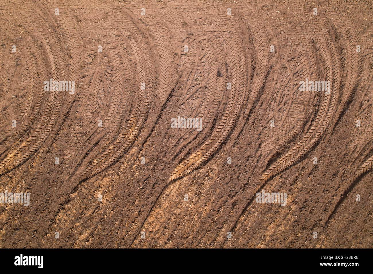 Pattern from tread wheel tracks on a plowed field. Stock Photo