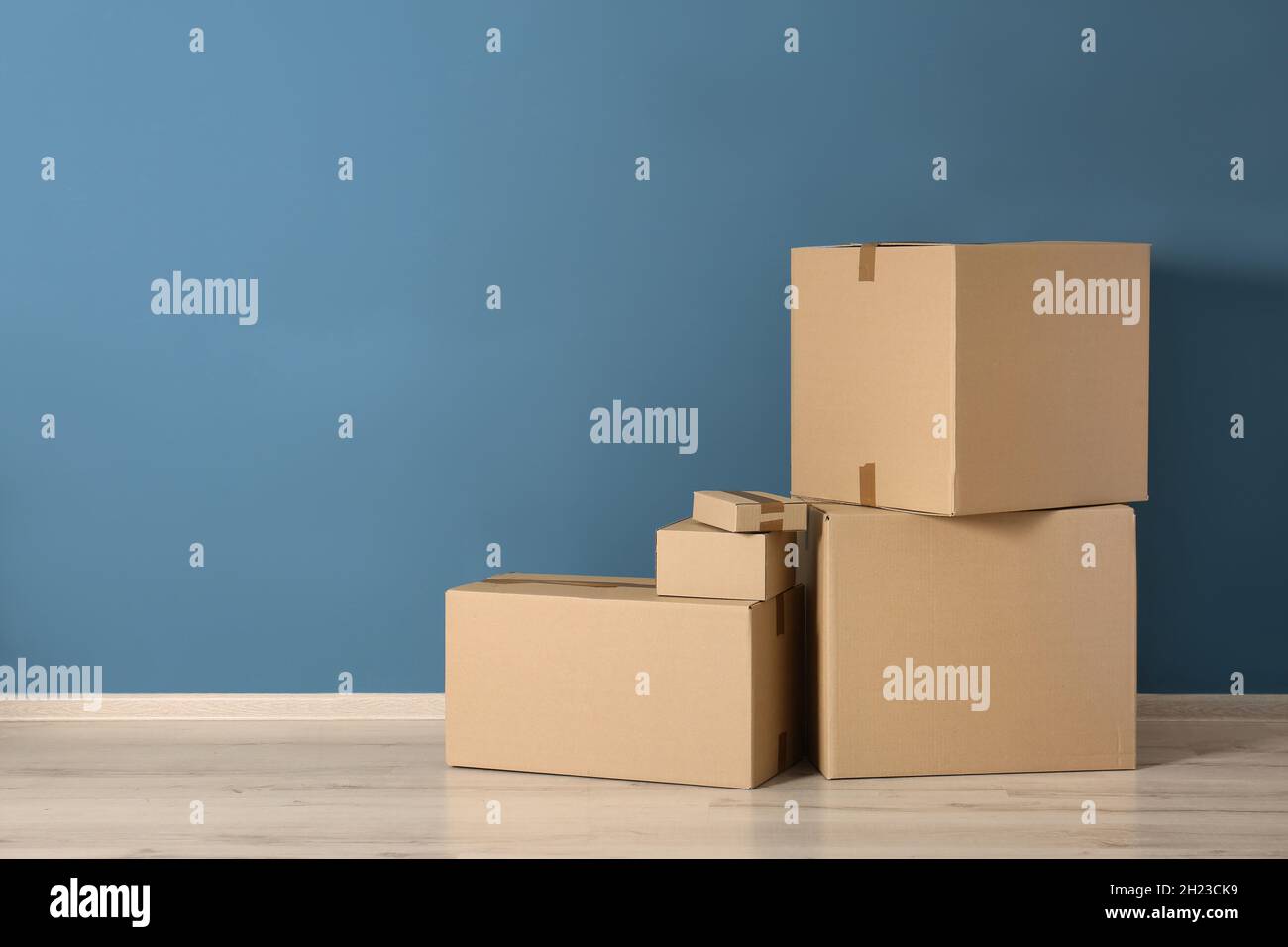Cardboard boxes near color wall Stock Photo Alamy