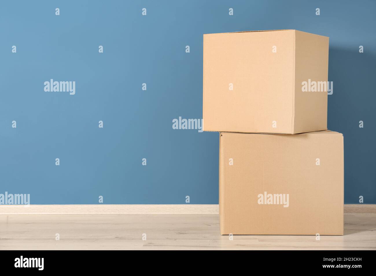 Cardboard boxes near color wall Stock Photo Alamy