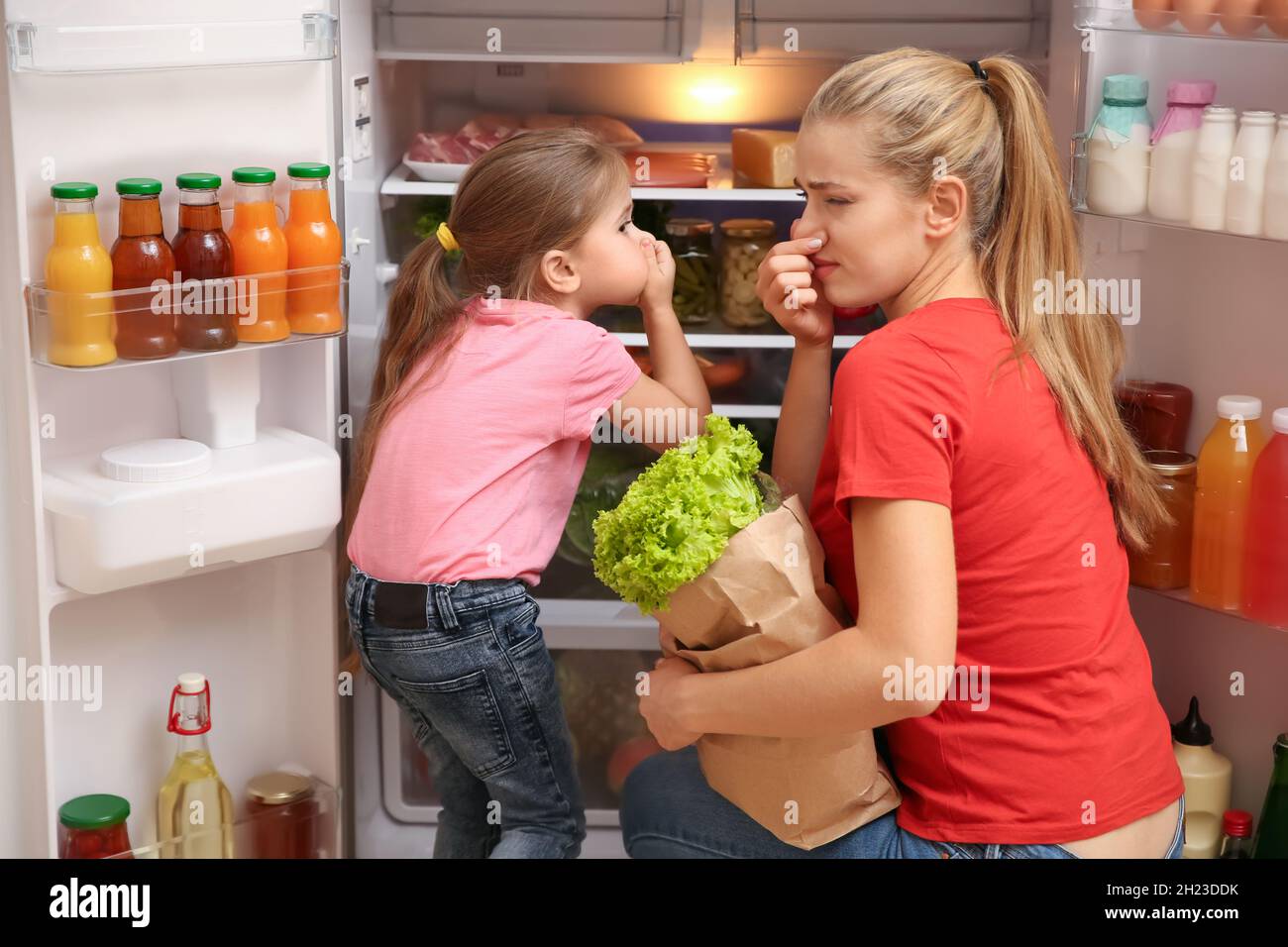 Young mother and daughter holding noses cause of bad smell from