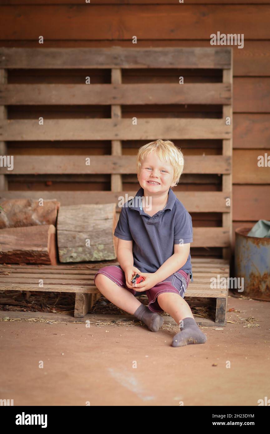 Little cute country boy posing on porch Stock Photo - Alamy