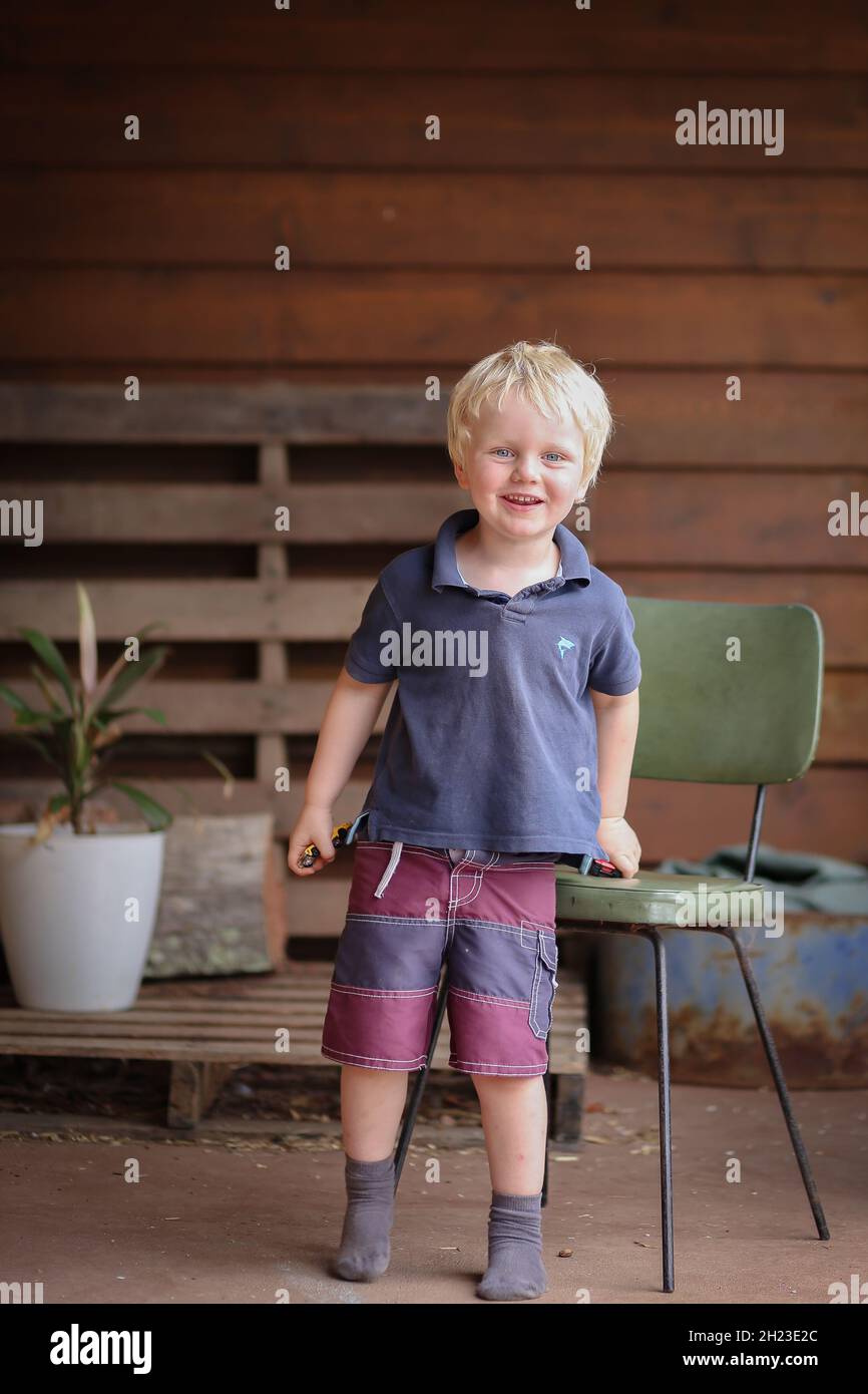 Little cute country boy posing on porch Stock Photo - Alamy