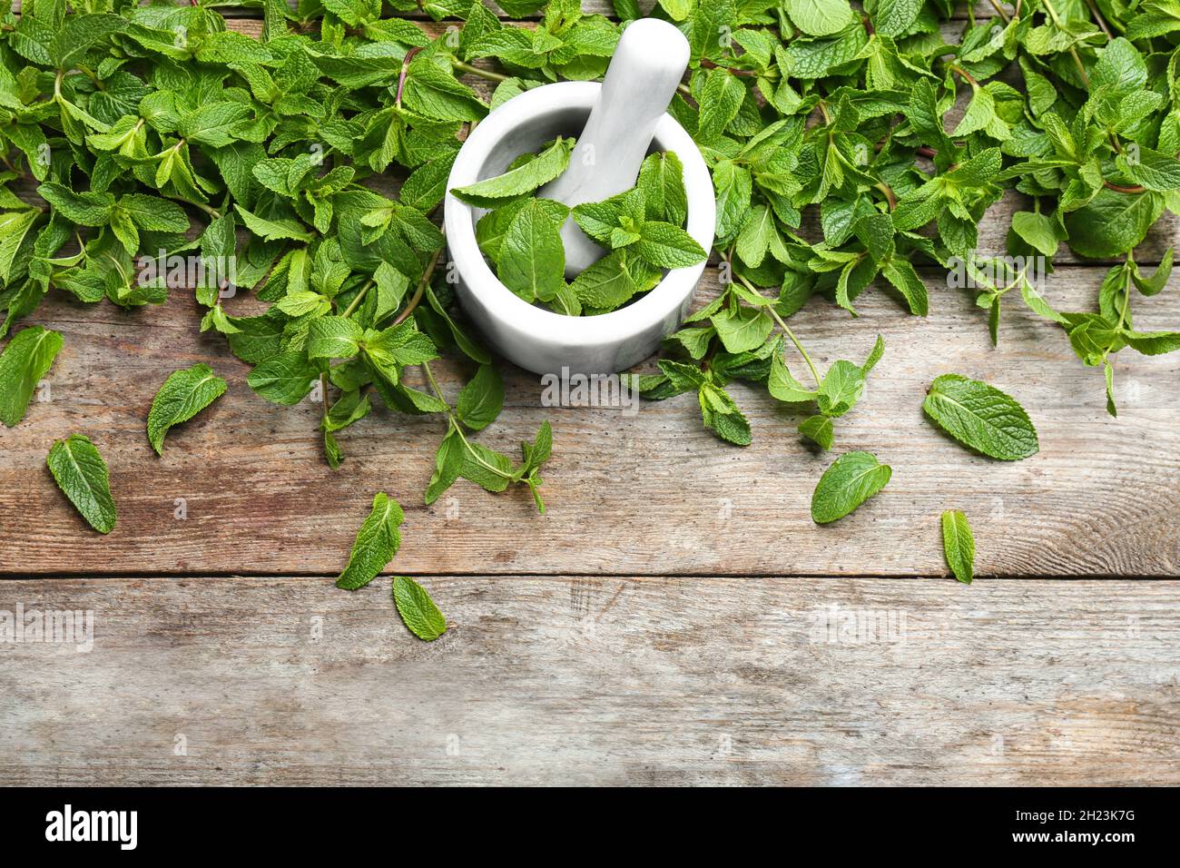 Flat lay composition with mint and mortar on wooden background Stock Photo