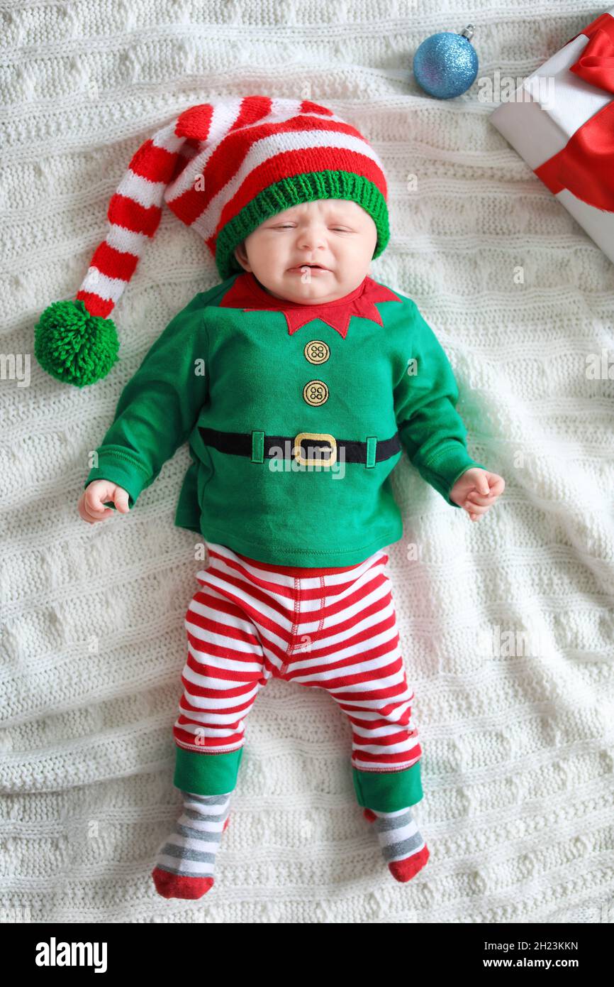 Cute baby in Christmas costume lying on blanket Stock Photo Alamy