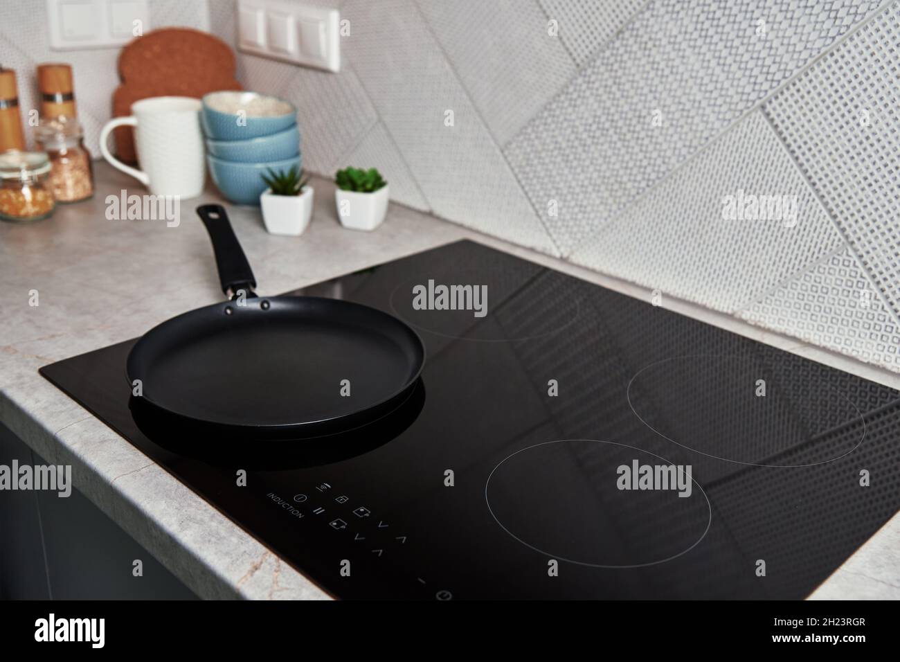 Modern kitchen appliance. Cooking pan on the surface of induction panel with sensor panel Stock