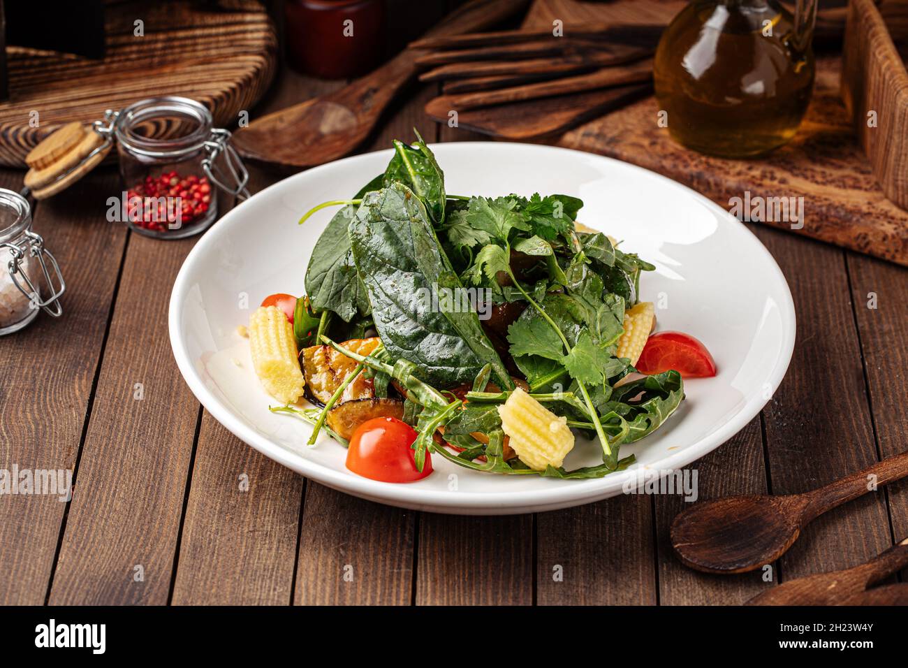 Healthy spinach salad with eggplant and baby corn Stock Photo
