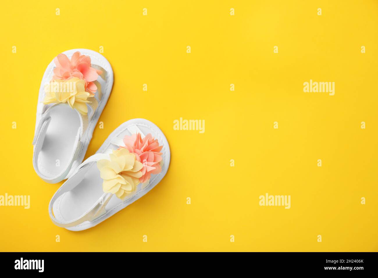 Pair of cute baby sandals on color background, top view Stock Photo - Alamy