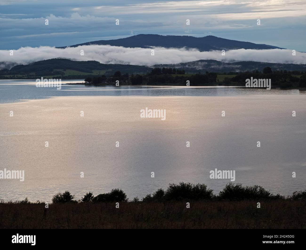 Fog over the lakeafter the storm, lake Lipno in the mountains Sumava, Czech Republic Stock Photo