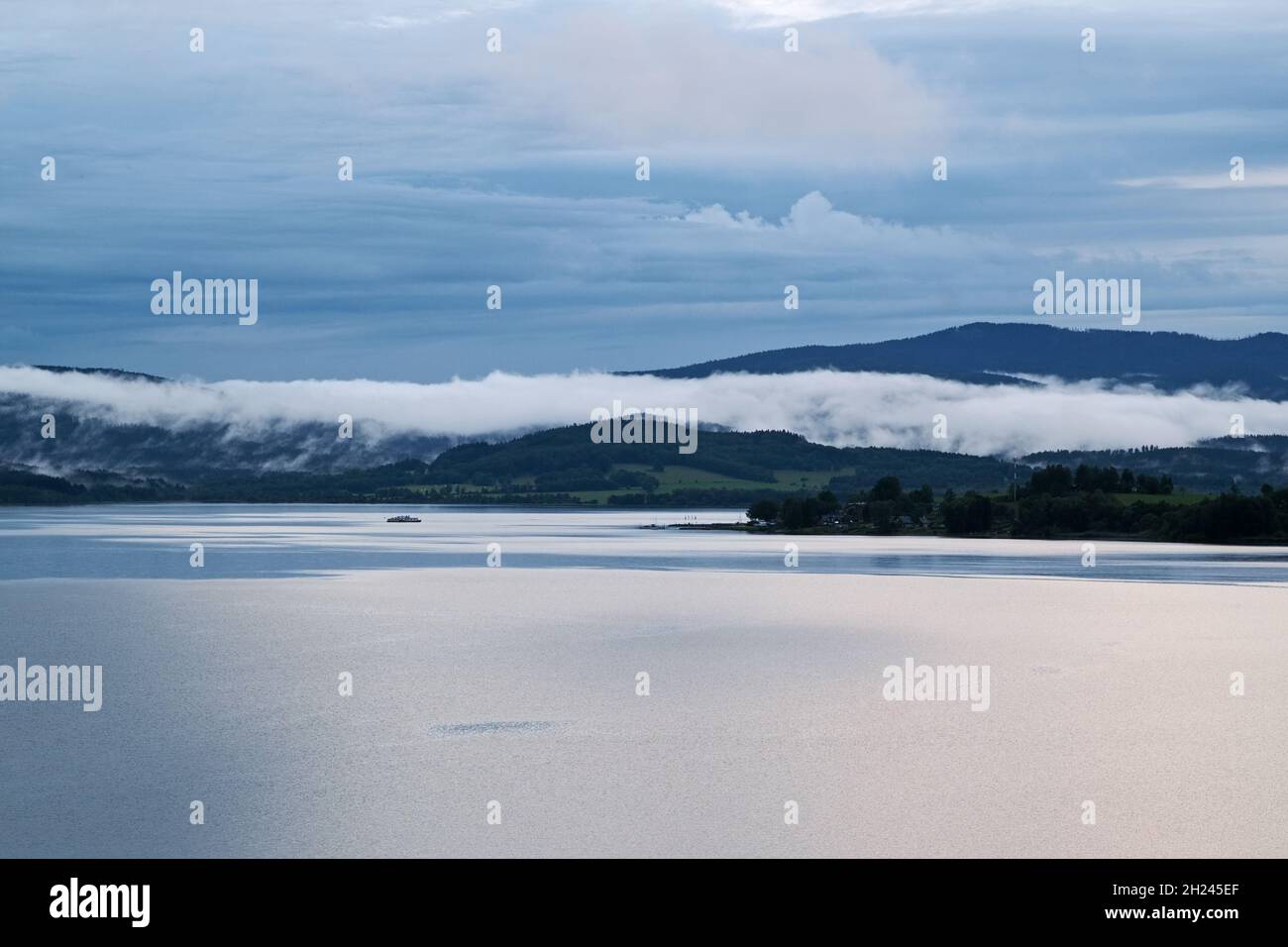 Fog over the lakeafter the storm, lake Lipno in the mountains Sumava, Czech Republic Stock Photo