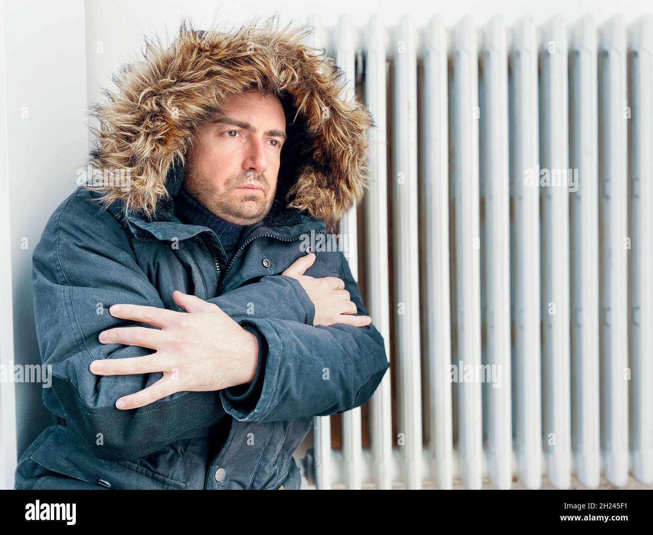 Man feeling cold at home with home heating trouble Stock Photo
