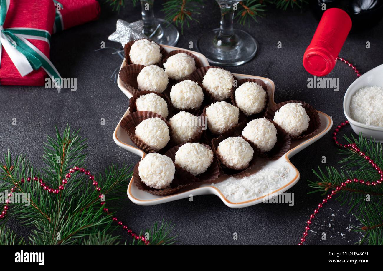 Sweet coconut rafaello candies served in plate as Christmas tree. Close-up Stock Photo