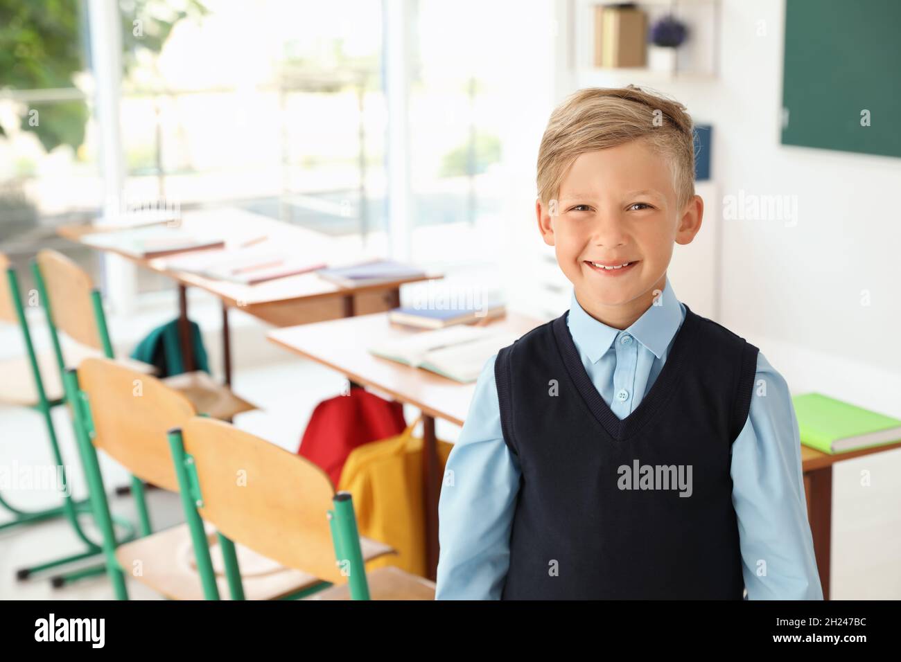 Little boy in classroom. Stylish school uniform Stock Photo Alamy
