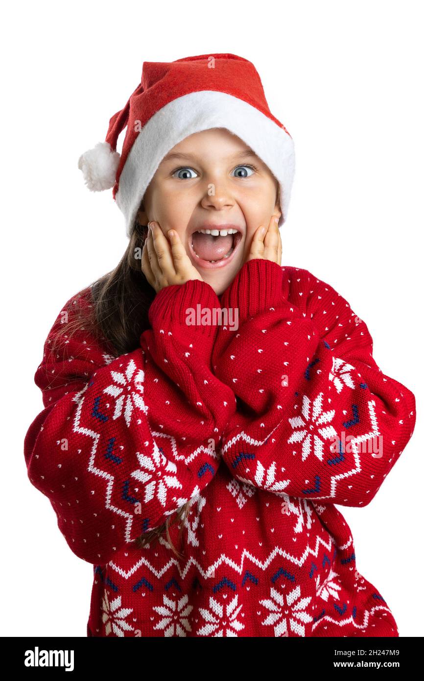 close-up portrait of delighted, surprised girl with mouth open in red knitted Christmas sweater with reindeer, isolated on white background Stock Photo