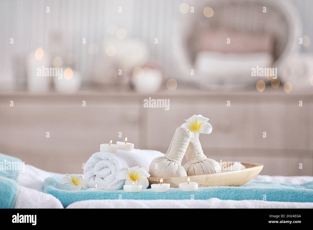 Supplies for massage on bed in modern spa salon. Place for relaxation