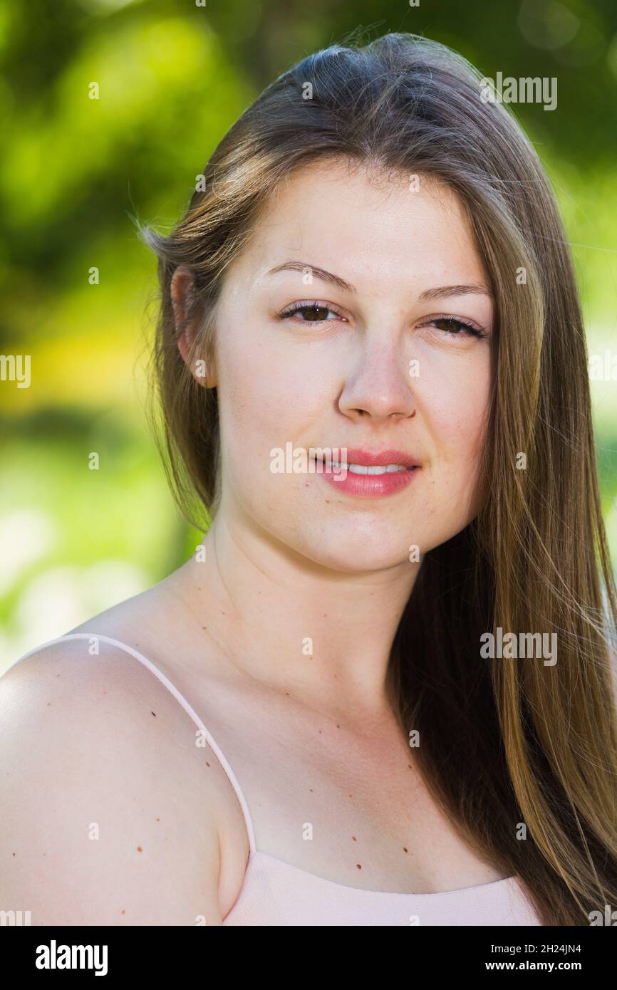 Portrait of young girl which is sitting on bench in the park Stock ...