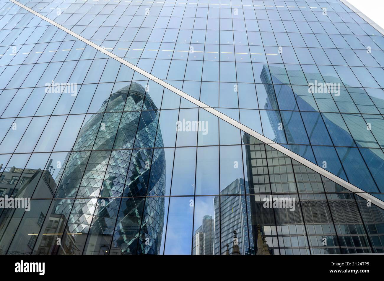 The Gherkin and The Cheesegrater buildings reflected in the glass facade of The Scalpel building in City of London, England. Stock Photo