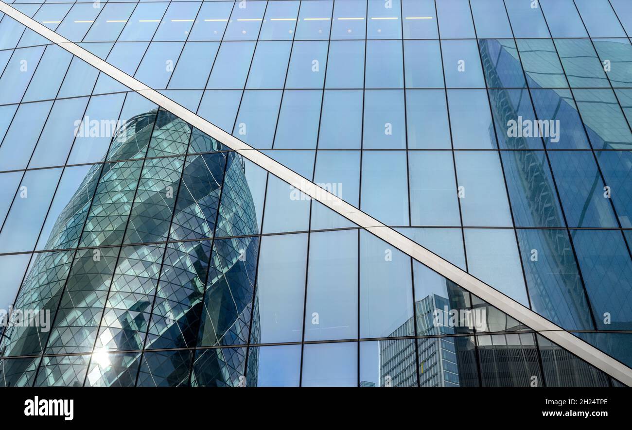 The Gherkin and The Cheesegrater buildings reflected in the glass facade of The Scalpel building in City of London, England. Stock Photo