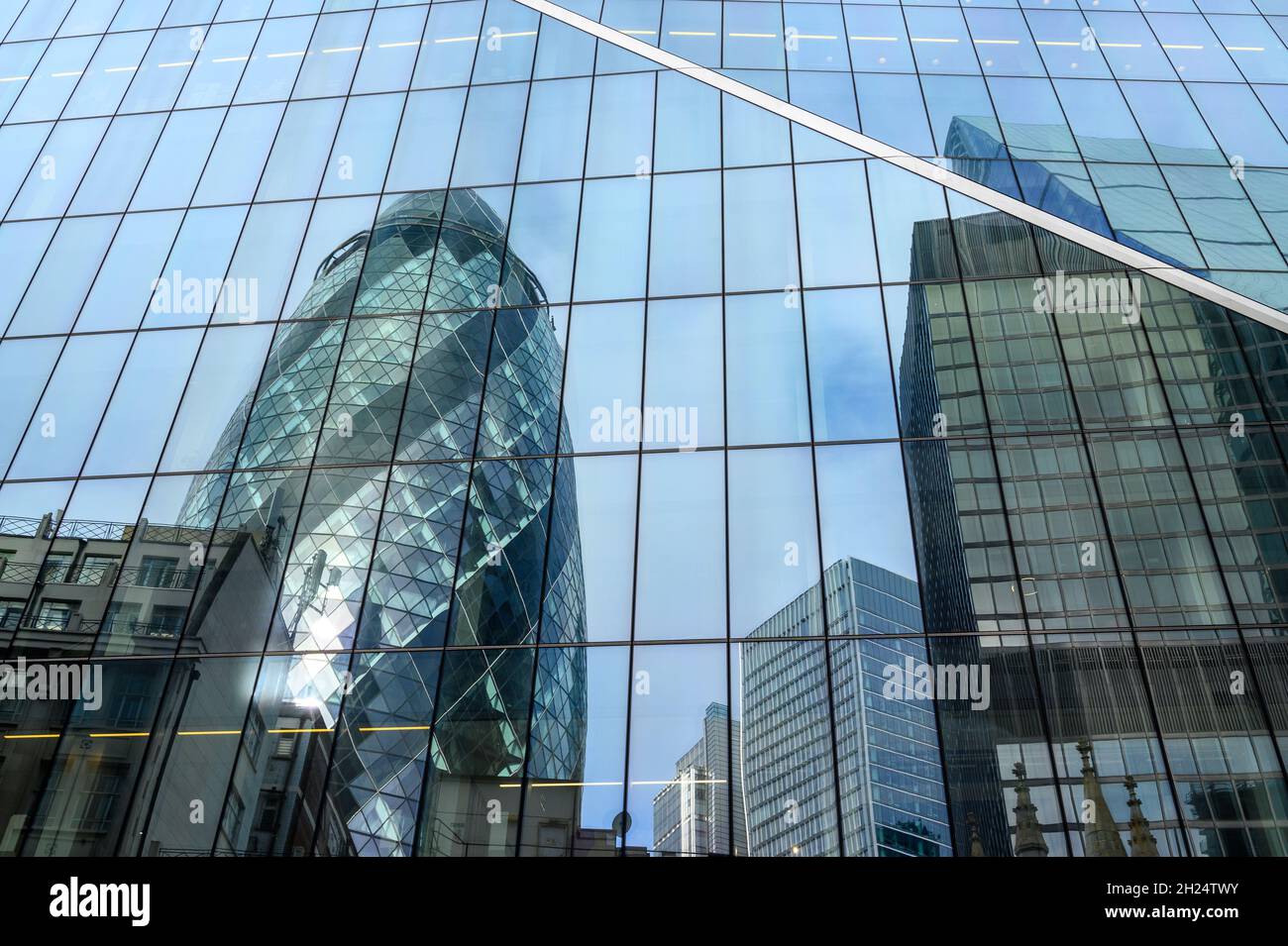 The Gherkin and other buildings reflected in the glass facade of The Scalpel building in City of London, England. Stock Photo