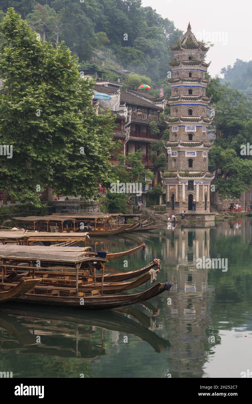 The Wanming Pagoda and tour boats on the Tuojiang River in Fenghuang, China. Stock Photo