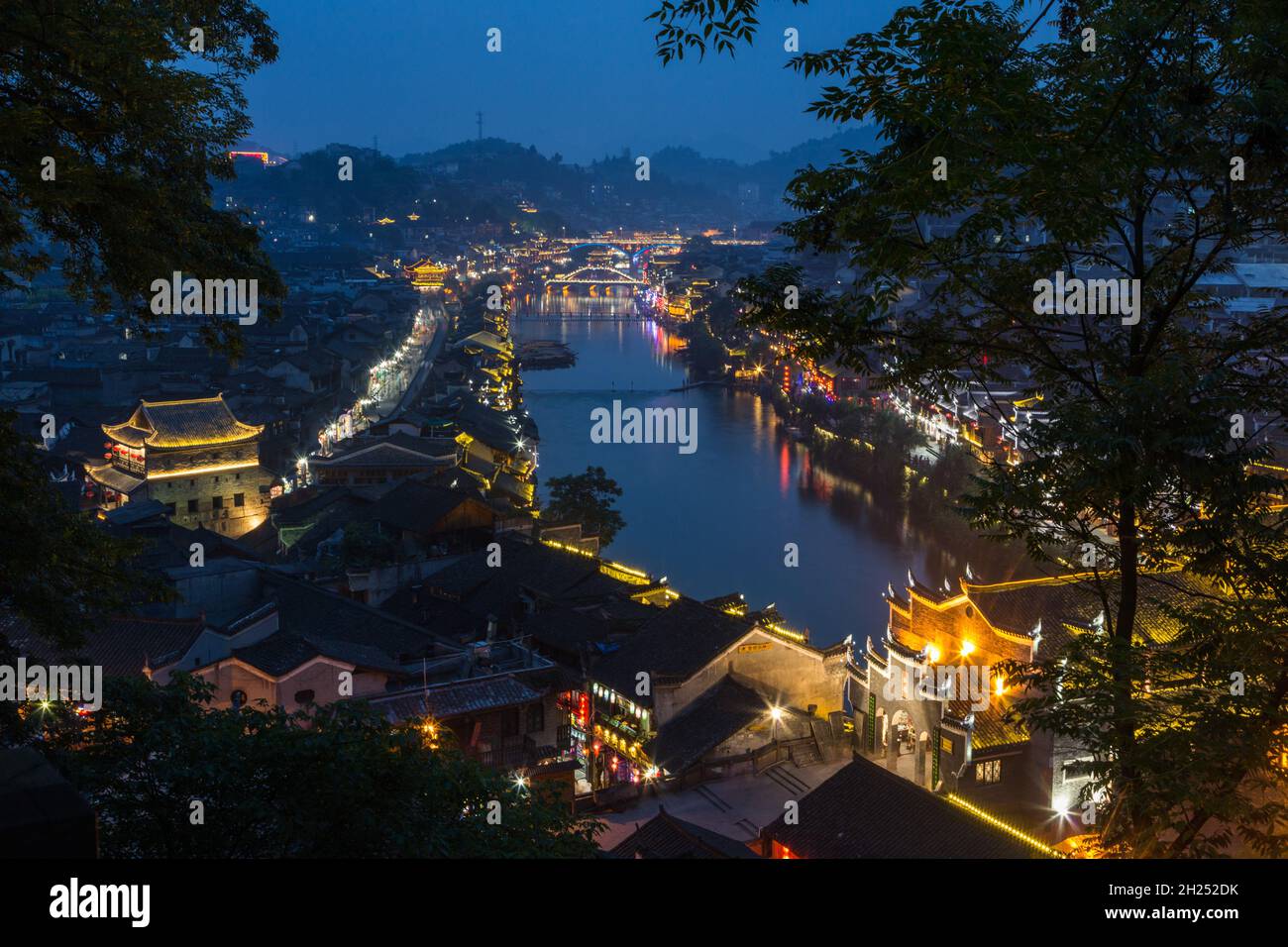Bridges over the Tuojiang River lit up at night in Fenghuang, China. Stock Photo