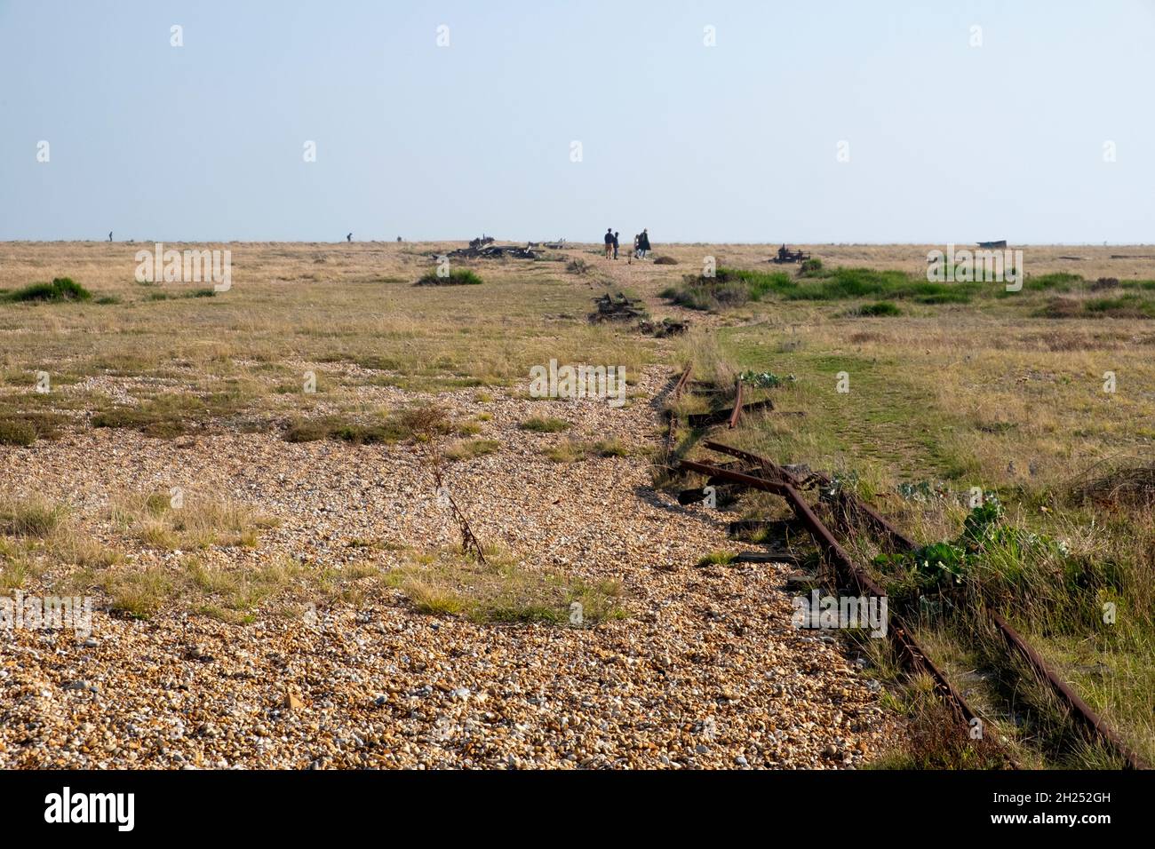 People walking on the Dungeness Estate arid desert landscape on the Kent coast near East Sussex in autumn Stock Photo
