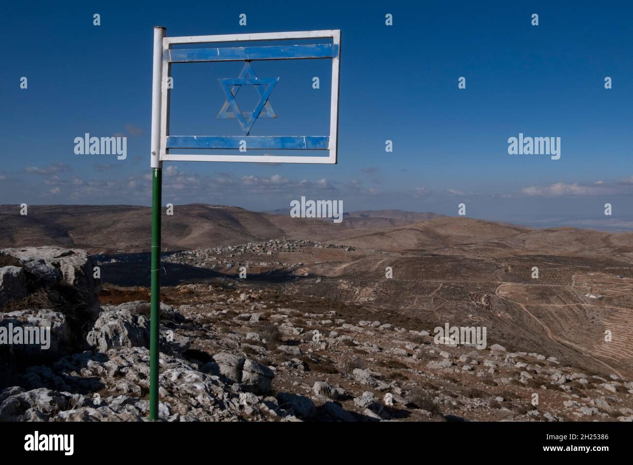 The Israeli flag made from steel placed at Matan Lookout overlooking the hills of Samaria also known as Nablus Mountains located on the Gidonim ridge (a hilltop on which several Jewish settlements are located), above the Israeli settlement of Itamar in the West bank. Israel Stock Photo