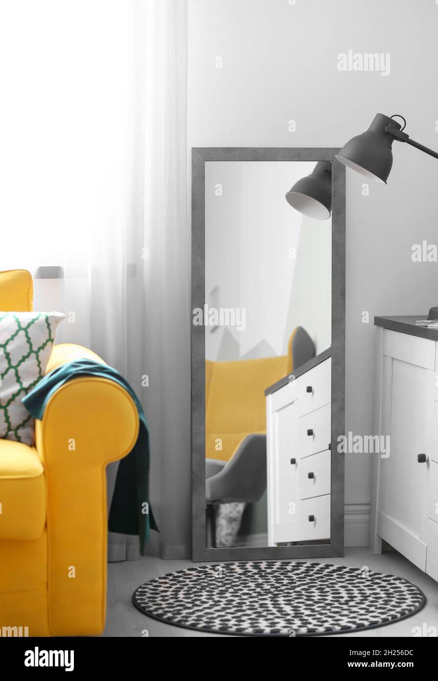 Stylish living room interior with large mirror. Idea for home decor