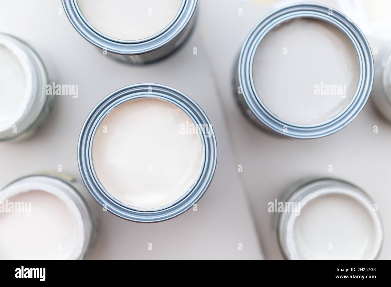 Tiny sample paint cans during house renovation, process of choosing
