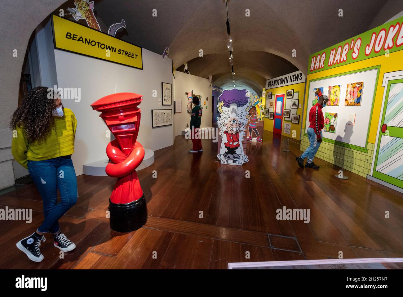 London, UK.  20 October 2021. A visitor views (L) 'Alphabetti Spaghetti', 2019, by Alex Chinneck.  Preview of “Beano: The Art of Breaking the Rules”, a new exhibition at Somerset House celebrating the world’s longest-running weekly comic and a British cultural icon: Beano. Curated by artist and lifelong Beano fan Andy Holden, works by writers, musicians, painters, sculptors and photographers are displayed alongside original comic artwork and artefacts from the Beano’s archive in an exhibition which runs 21 Oct 2021 to 6 Mar 2022.  Credit: Stephen Chung / Alamy Live News Stock Photo