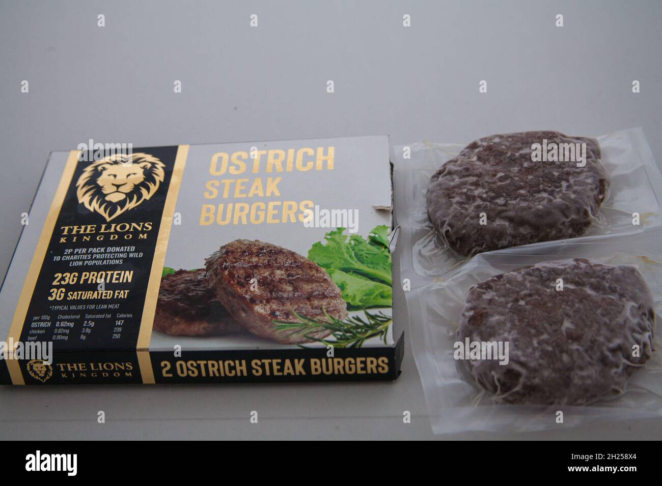 Two frozen Ostrich Steak Burgers thawed to cook Stock Photo Alamy