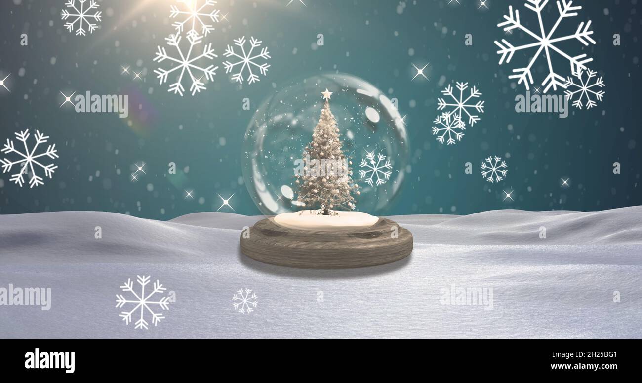 Image of snow falling over snow globe with christmas tree in winter