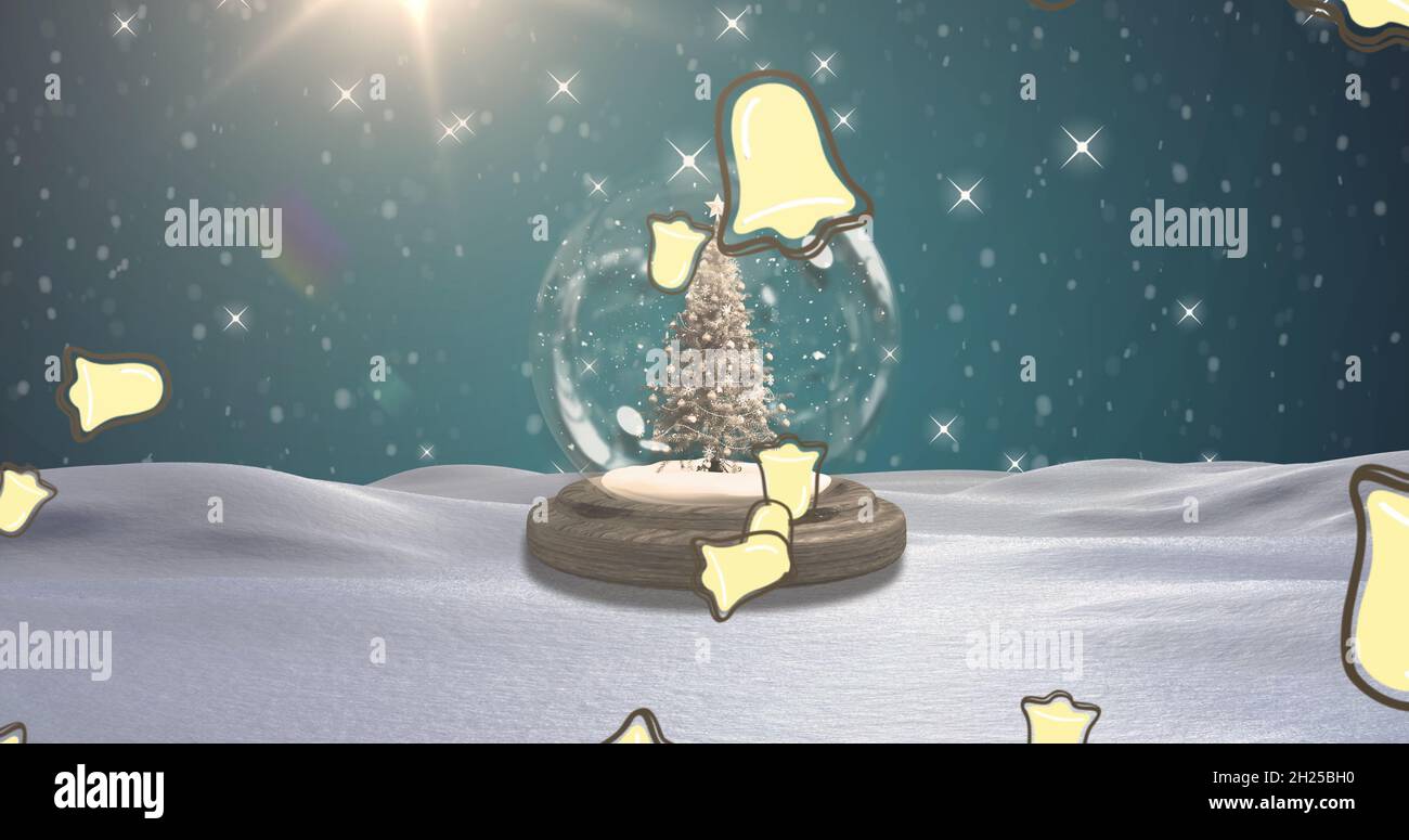 Image of falling christmas bells over snow globe with christmas tree in winter scenery Stock Photo