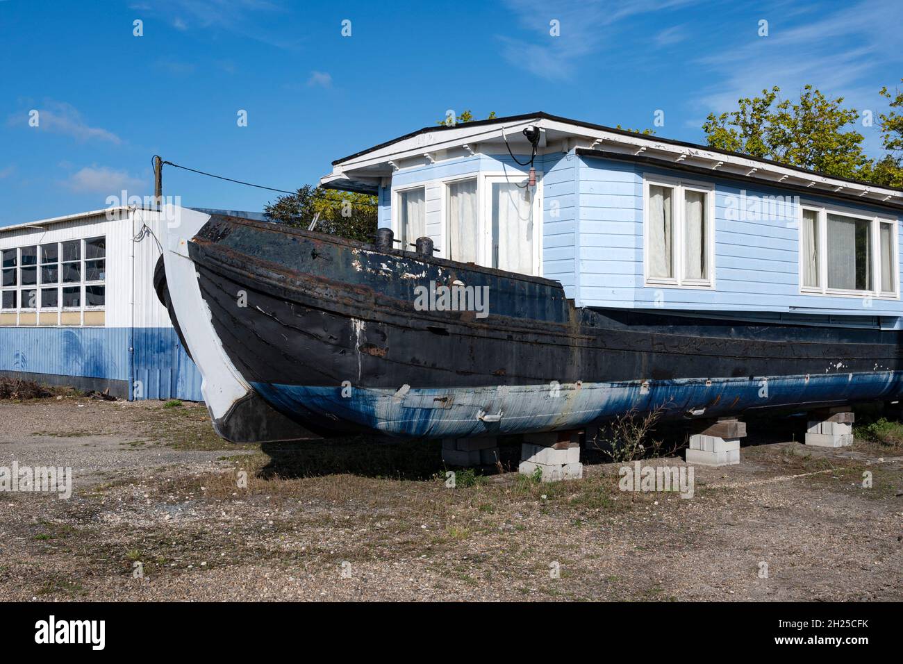 An old houseboat parked on the pleasure boat docks at the bassins à flot, Bordeaux, France Stock Photo