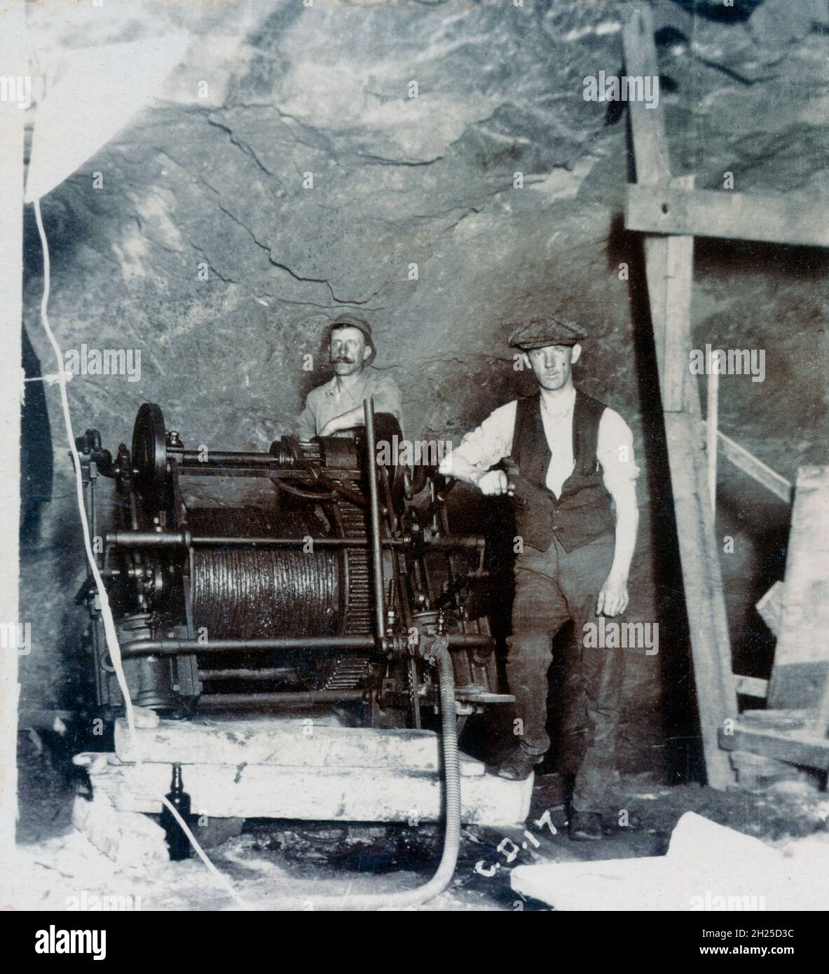 Miners with cable winch underground, probably in City Deep gold mine, Johannesburg, South Africa about 1920 Stock Photo