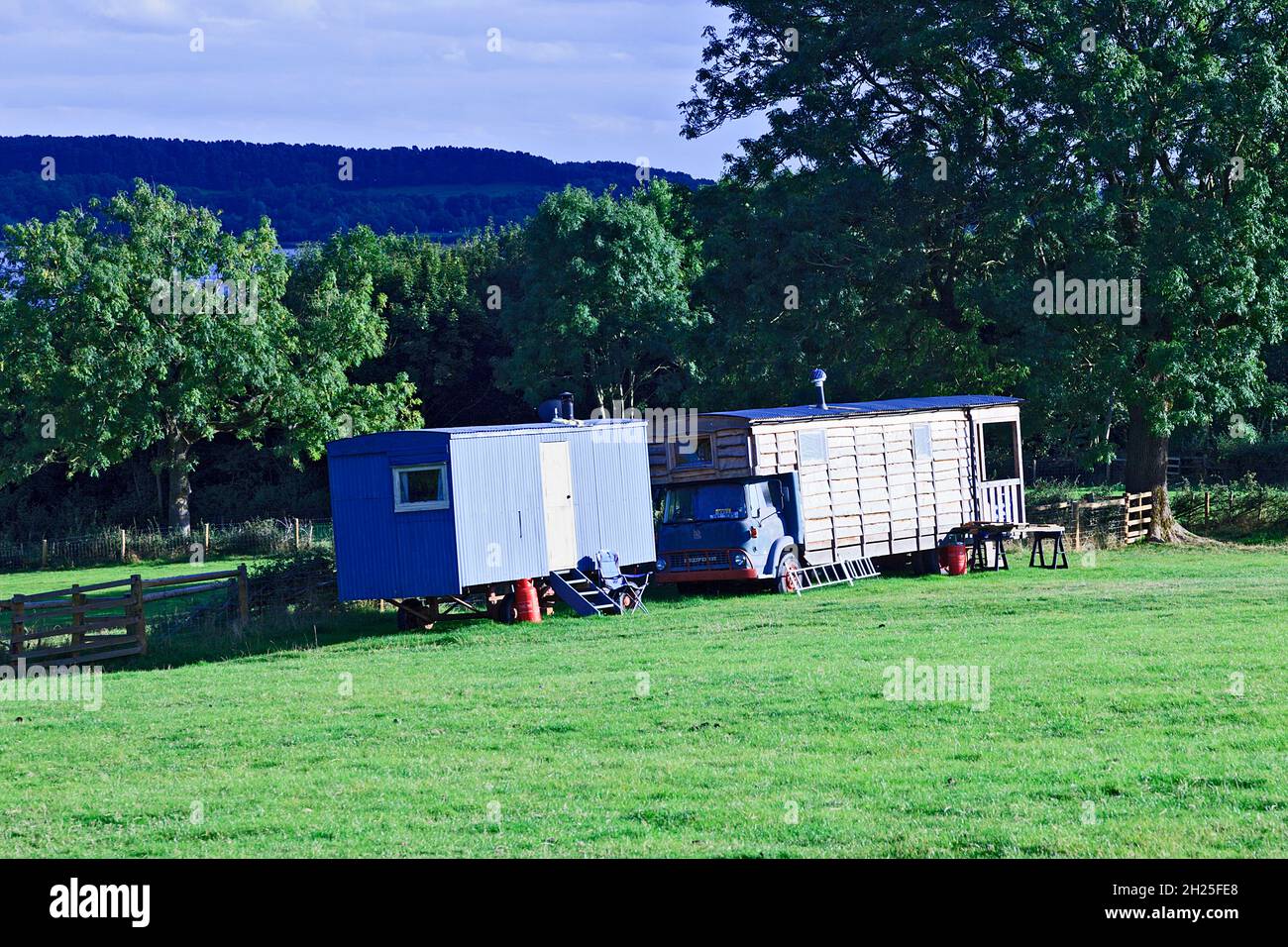 Horse box converted to temporary living in farm field at