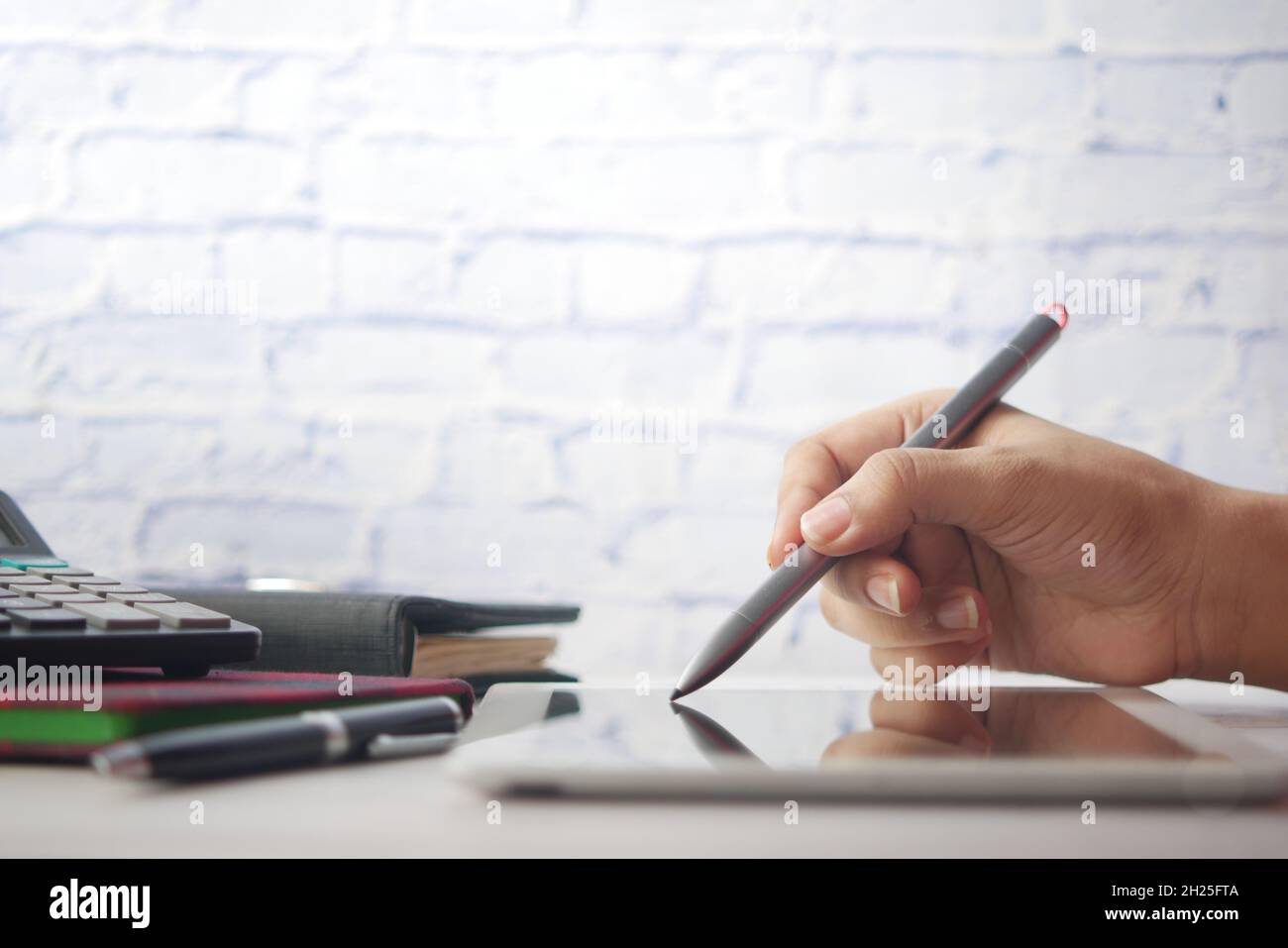 women's hand working on digital tablet with graphic pen  Stock Photo
