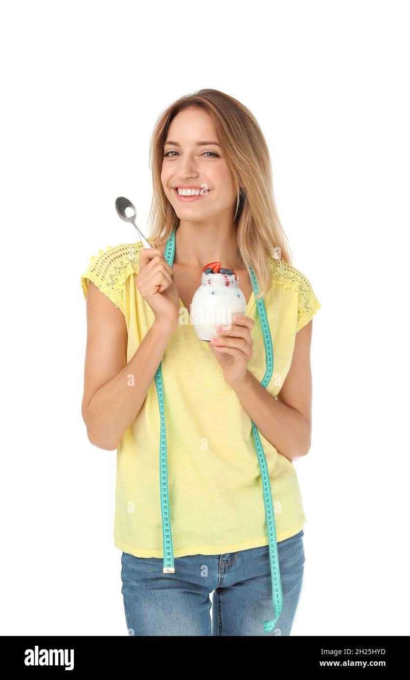 Happy slim woman with measuring tape and yogurt on white background