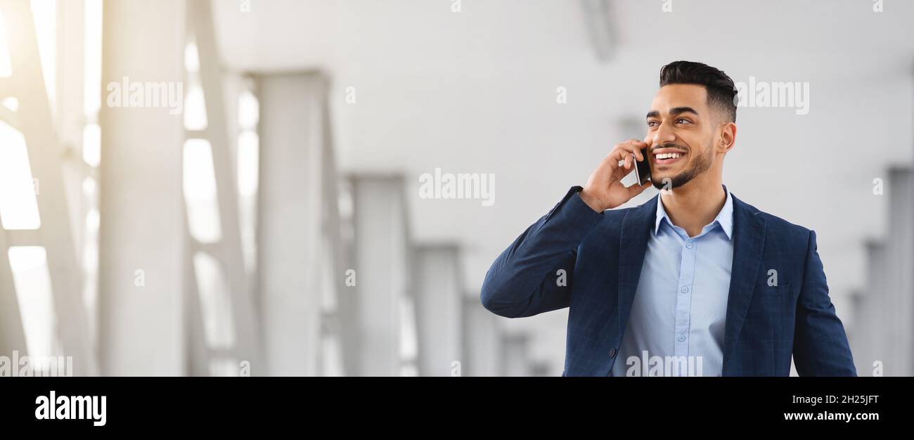 Business Call. Handsome Young Arab Man Talking On Mobile Phone Stock Photo