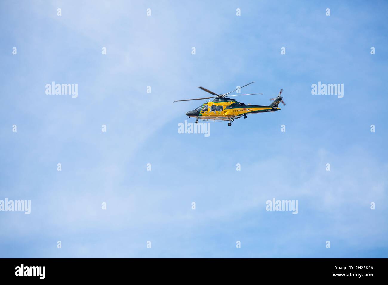 Bologna, Emilia Romagna, Italy: 2021 October 20. Yellow finance guard helicopter in the sky Stock Photo