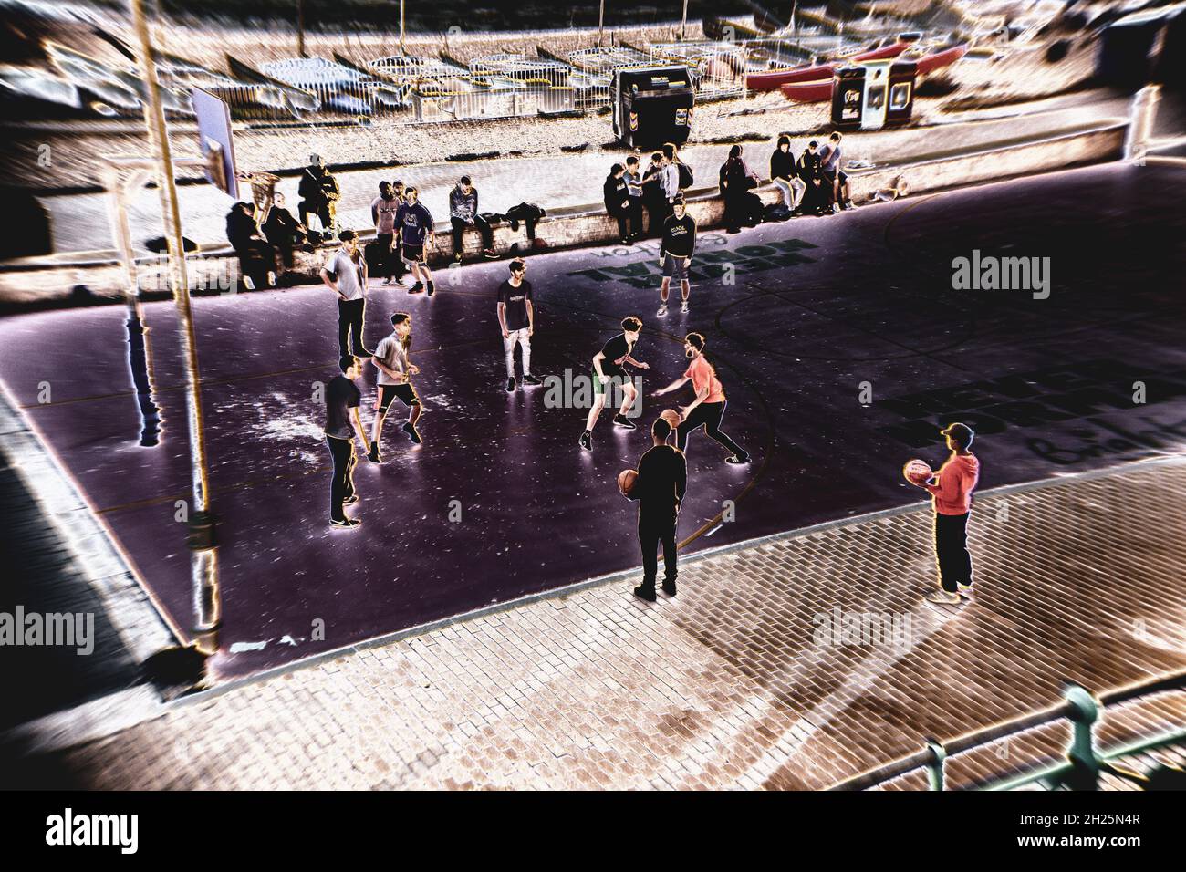 Young people playing basketball at Brighton seafront in a distorted ...