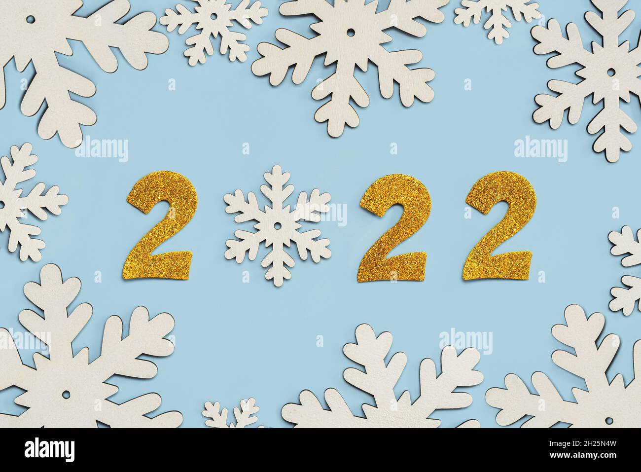 Happy new year 2022. Golden Numbers 2022 with snowflakes.New Years Eve celebration concept background over blue background. New Years Eve celebration Stock Photo